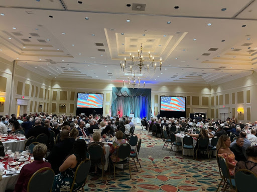 A large conference room filled with tables and people