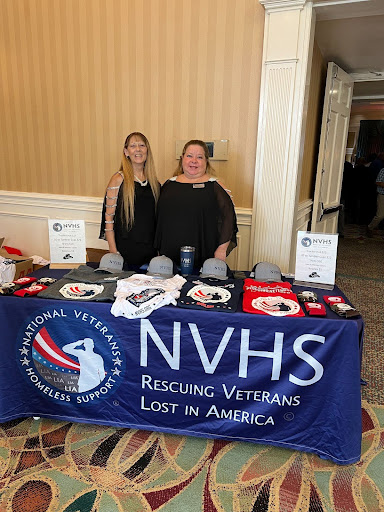 two ladies standing at an NVHS table 